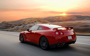 timelapse photography of red sports car on road with view of sun HD wallpaper