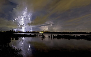 photo of thunder near body of water during night time HD wallpaper