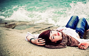 woman in blue jeans lying on groudn