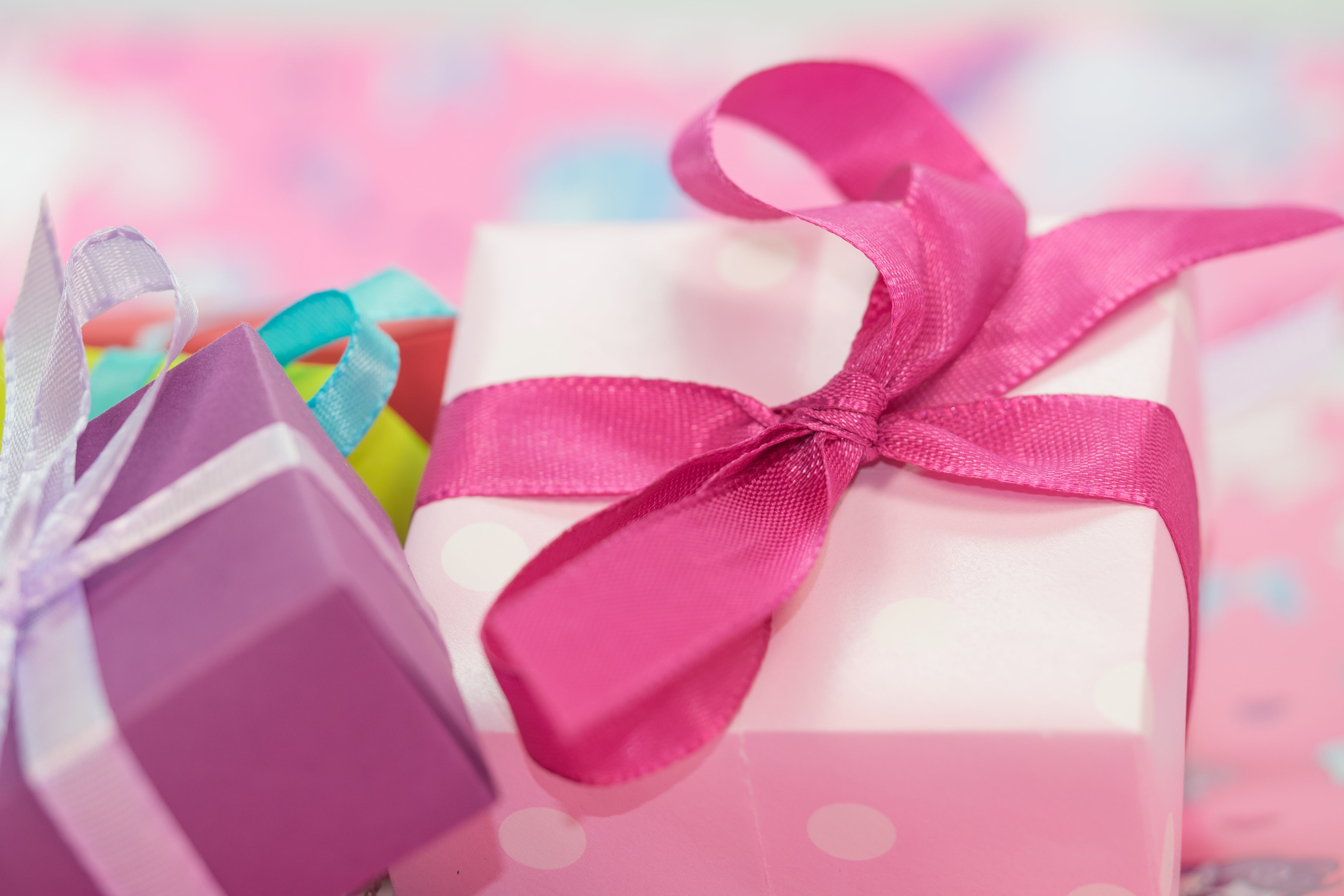 selective focus photography of pink and purple boxes