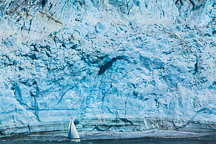 white sailboat near the iceberg