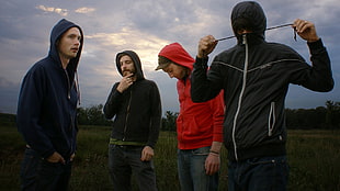 photo of four men in assorted colors zippered hoodies