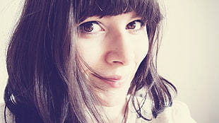 photo of smirking woman wearing white top HD wallpaper