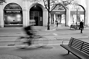 grayscale photo of man riding bike on road, zürich, ilford