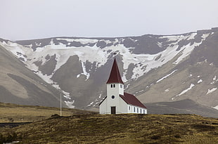 landscape photography of white chapel near mountain, vik, iceland