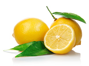 sliced and two lemons with white background