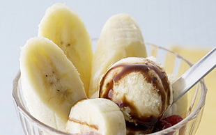 sliced of banana with ice cream in clear glass bowl
