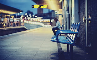 blue metal gang chair on train station