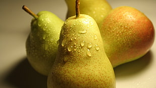 four yellow pear fruits