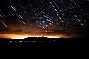 time lapse photography of falling stars during nighttime