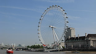 white Ferris wheel near body of water