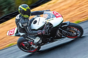 time-laps photo of man riding a Honda sport bike