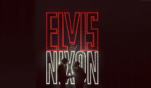 two men standing in front of an Elvis and Nixon LED signage