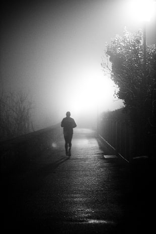 silhouette of man running during night time