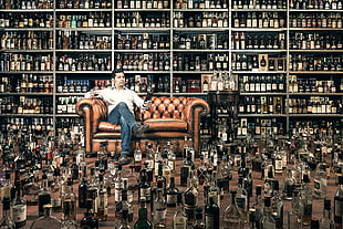 two brown wooden framed white padded chairs, bottles, men, alcohol, legs crossed