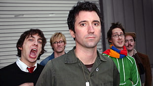 five men in assorted-color tops standing