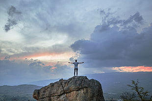 man on top of rocky mountain HD wallpaper