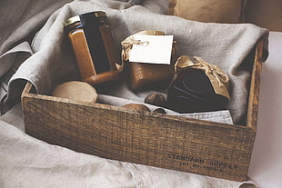 two clear glass mason jars and square brown wooden crate