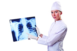 woman wearing medical suit holding X-ray result