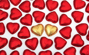 gold and red hearts in closeup photography