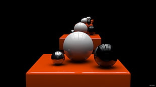 two black and one white balls on orange platform optical illusion