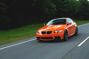 orange BMW coupe on road during daytime
