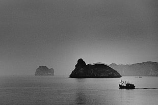 greyscale photography of boat on body of water