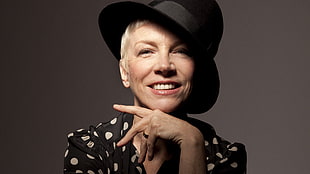 woman in black and white polka dot top wearing black fedora hat
