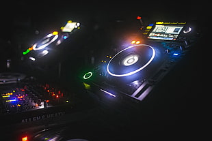 black DJ controller, turntables, mixing consoles