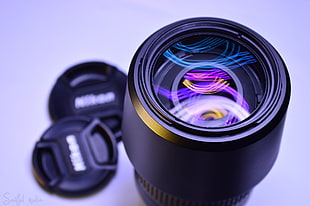 black Nikon zoom lens with covers