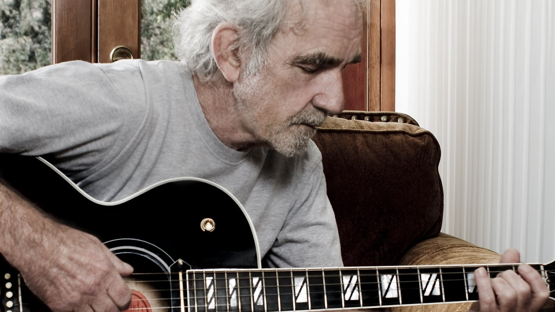 man holding a acoustic guitar