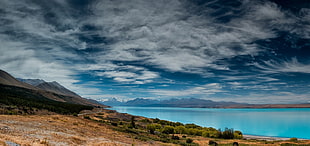 body of water, lake, road, clouds, mountains