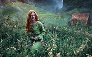 green-dressed woman in green grassland during daytime