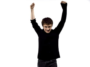 Man in black sweatshirt raising his hands