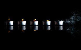 five silver-framed candle with light