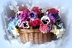 white, pink, and purple flowers in brown wicker basket