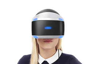 woman wearing white and black VR goggles