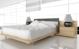 black and beige wooden bed frame with white comforter near 2-drawer nightstand with two table lamps