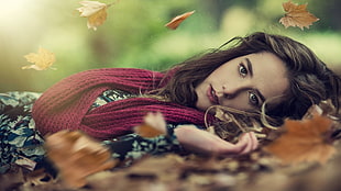 low angle photography of woman laying on leaves