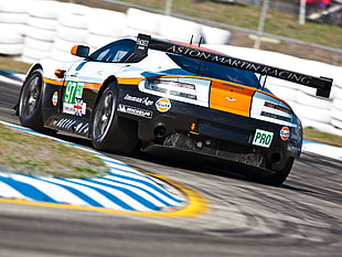 black and white Aston Martin vanquish racing car on track