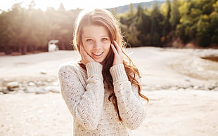 brown haired woman wearing white knitted sweater during daytime