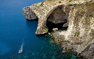 brown cliff, sea, cliff, cave, island HD wallpaper