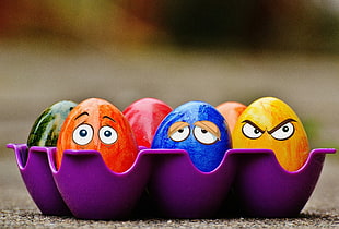 selective focus photography of colorful eggs in egg tray
