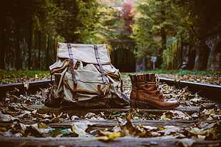 photography of brown boots and backpack