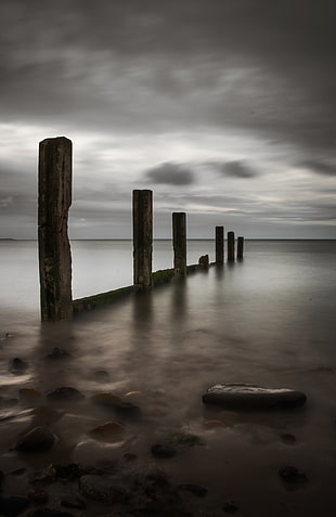 landscape photography of sea under gray cloudy sky