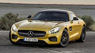 yellow Mercedes-Benz coupe parked on concrete pavement