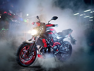 black and red Yamaha motorcycle covered in smoke