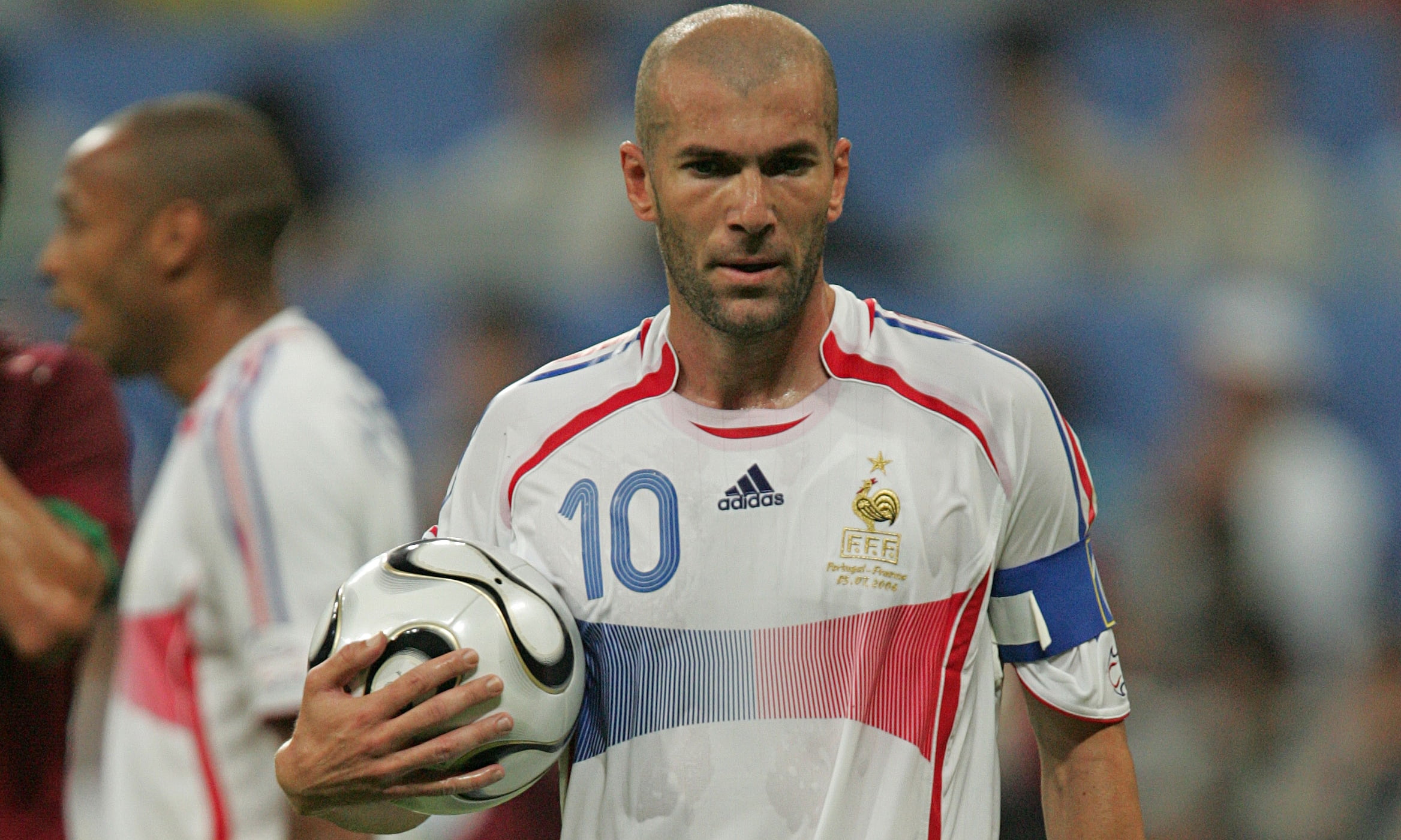 soccer player holding white Nike ball