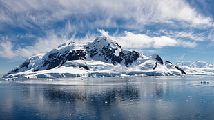 photography of ice mountain under white clouds