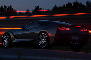 timelapse photography of black Corvette sports coupe